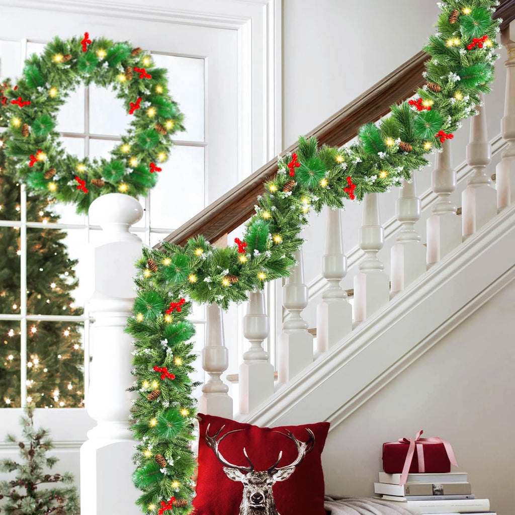 Christmas garland and wreath decorated with pinecones, red berries, and LED lights on a staircase and door.