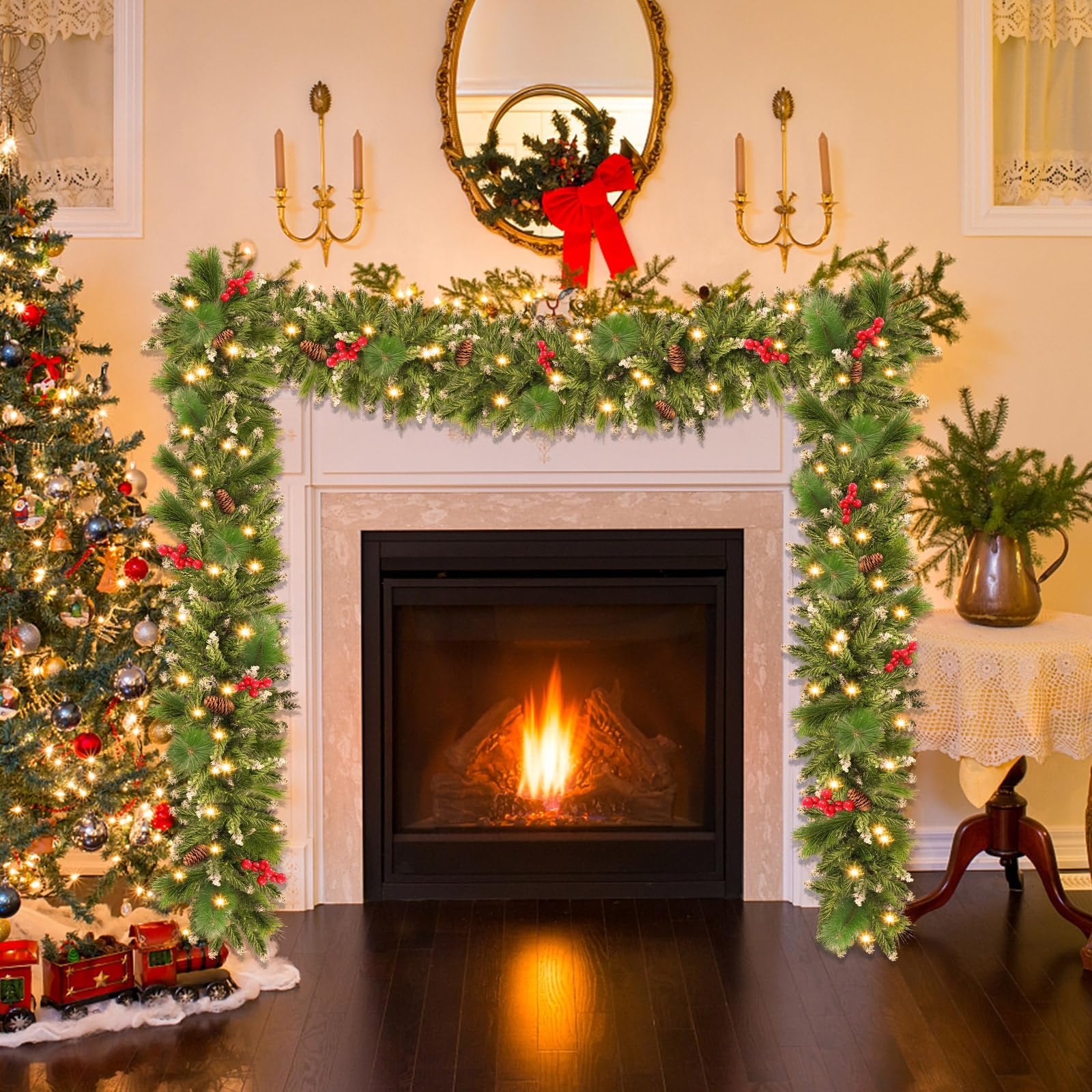 Prelit Christmas garland with pinecones and red berries draped over a fireplace, next to a decorated Christmas tree.
