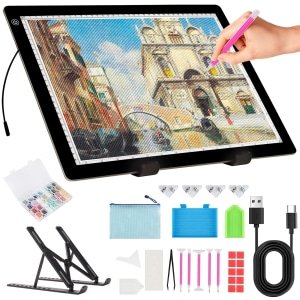 LED light pad for diamond painting and tracing, showing a building scene, with included accessories and stand.