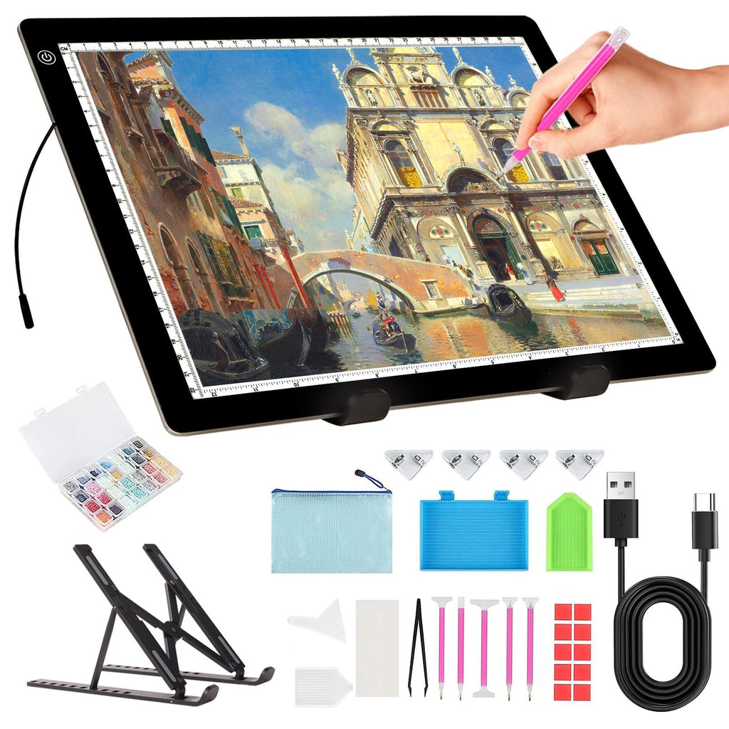 A4 LED light pad with stand, diamond painting kit, and accessories laid out on a white background. A hand is shown using a pink stylus on the light pad.