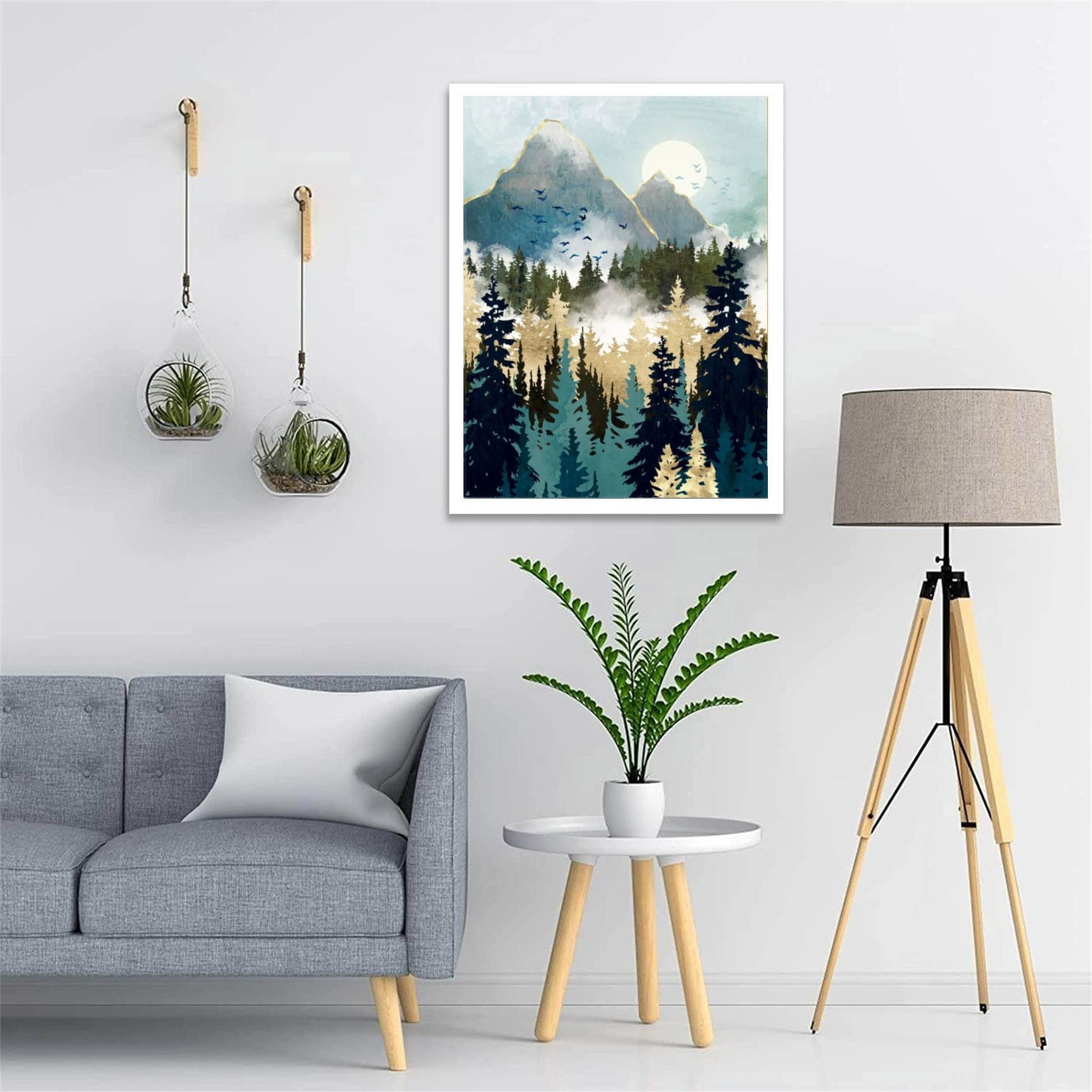 Abstract mountain forest landscape painting with sun and birds, displayed in a living room setting.