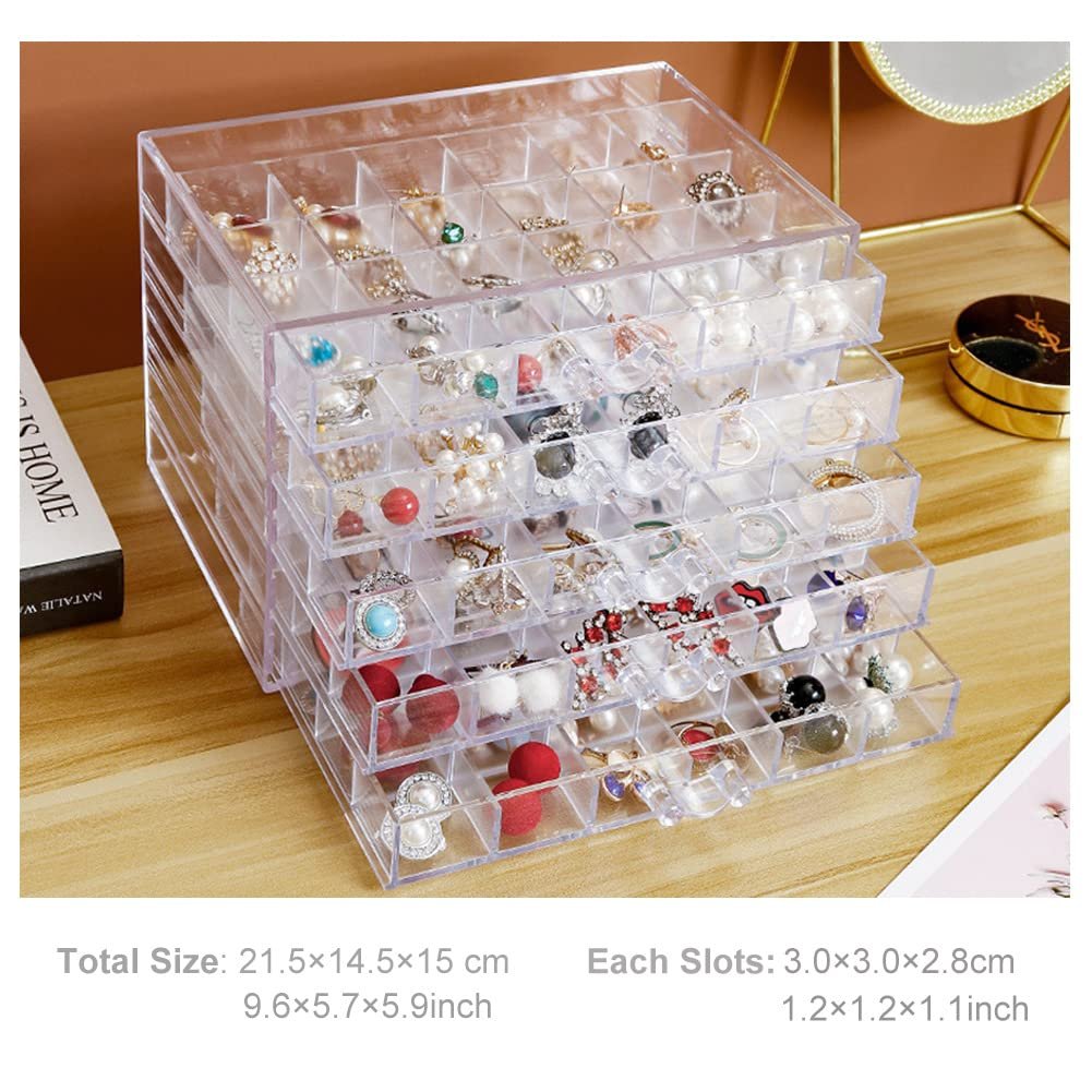 Clear acrylic earring organizer with 5 drawers filled with jewelry, shown at an angle on a wooden surface.