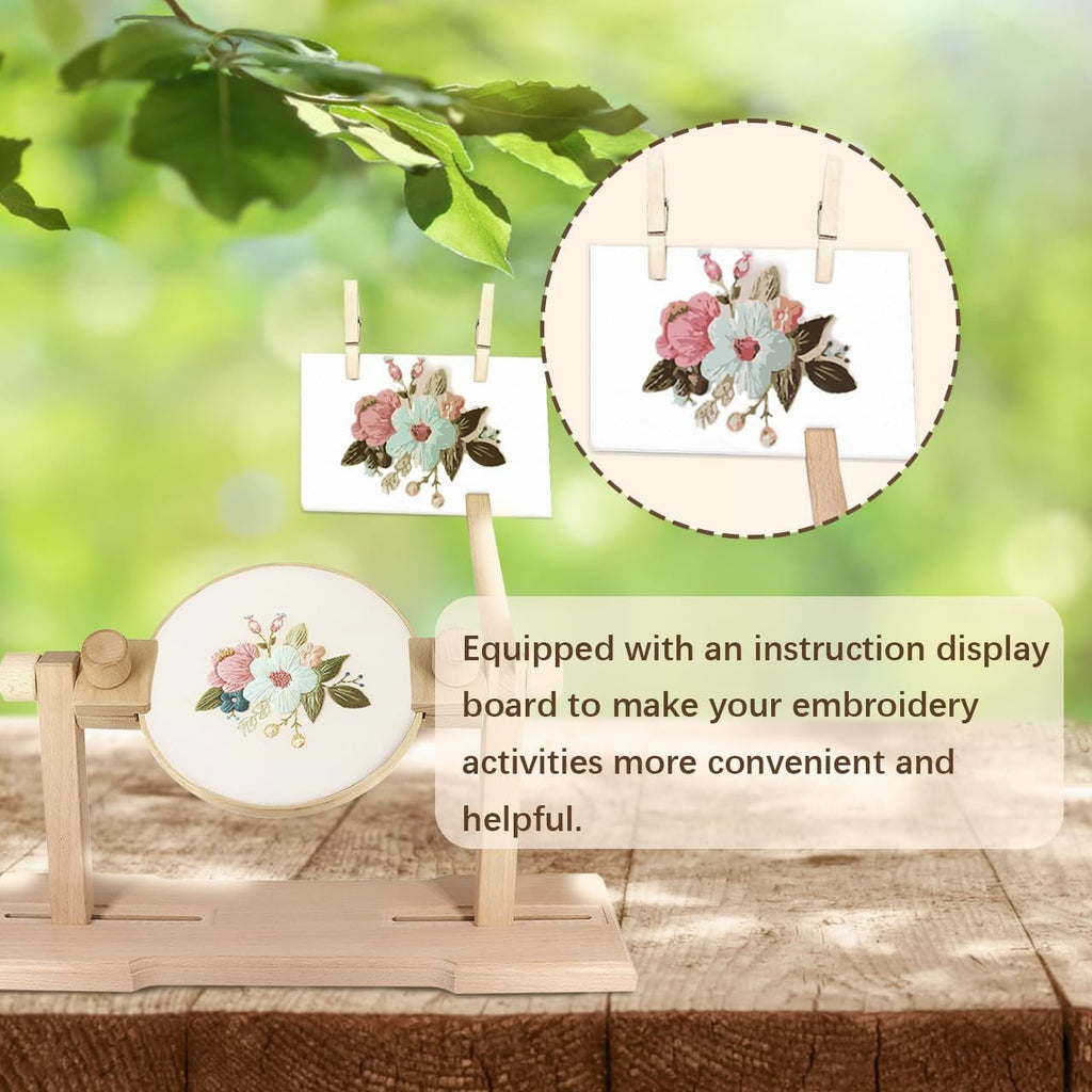 Wooden embroidery hoop stand with a floral design on fabric, set against a blurred green background with two small floral cards hanging.