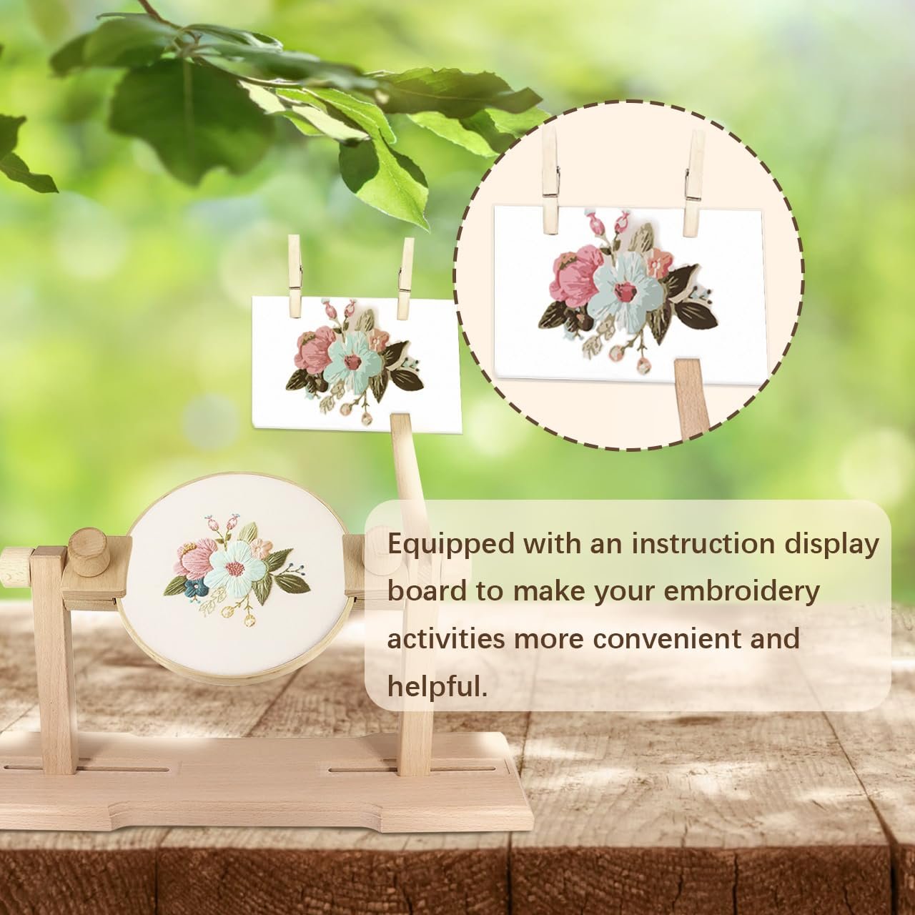 Wooden embroidery hoop stand with a floral design on fabric, set against a blurred green background with two small floral cards hanging.
