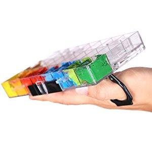 Hand holding a clear paint palette box with 24 deep wells filled with colorful paints.