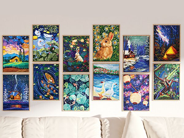 Collection of framed diamond art paintings displayed on a wall above a sofa