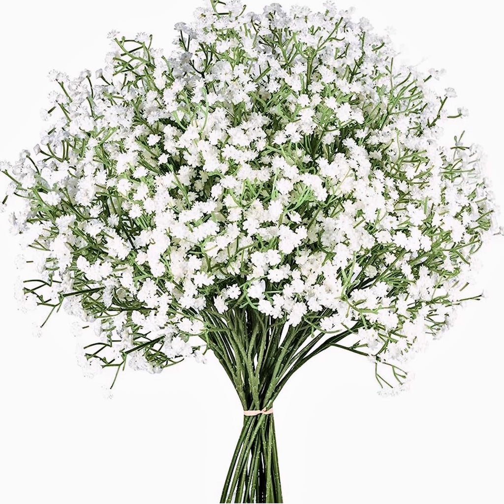 Bundle of artificial white baby's breath flowers with green stems tied with a pink band, isolated on white.