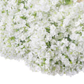 Close-up of a bouquet of white artificial baby's breath flowers with green stems, filling most of the frame.