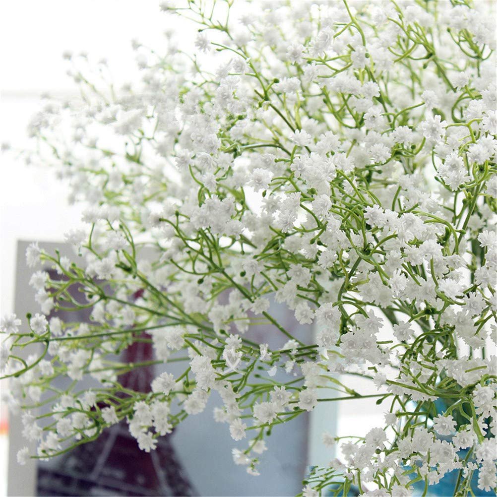 Close-up of artificial white baby's breath flowers with green stems, arranged in a bouquet.