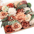 Box of assorted artificial flowers in terracotta, champagne, amber, cream, and burnt orange colors with green leaves.