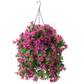 Hanging basket with artificial violet flowers and green leaves, suspended by a metal chain against a white background.