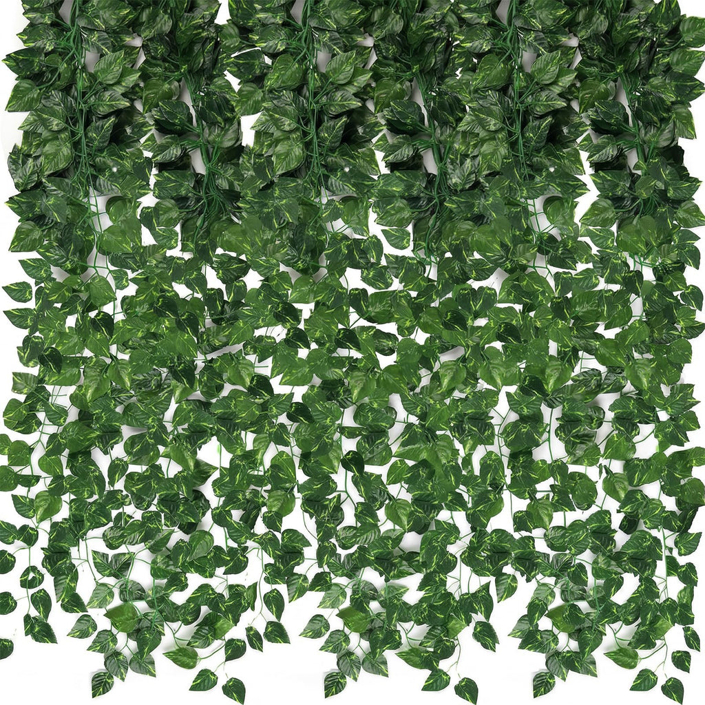 Artificial ivy vines with green silk leaves and plastic stems cascading down against a white background.