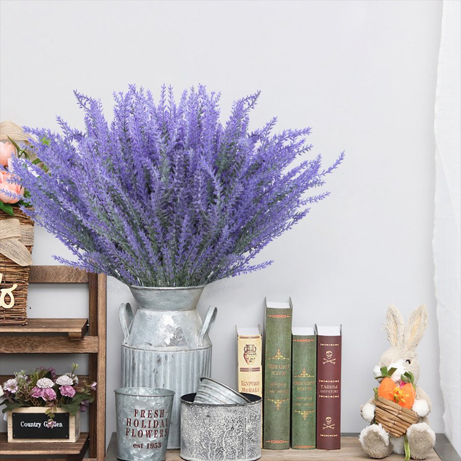 Artificial lavender bundles in a galvanized vase with books and a bunny decoration on a shelf