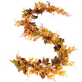 Artificial maple leaf garland with autumn foliage in orange, yellow, red, and green on a white background.