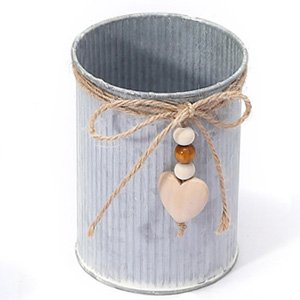 Galvanized metal pot with corrugated texture, tied with twine and a wooden heart charm with beads.