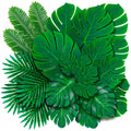 Assortment of artificial palm and monstera leaves in various sizes on a white background
