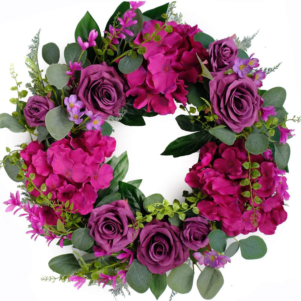 Artificial purple rose and hydrangea wreath with eucalyptus leaves on a white background
