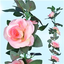 Close-up and smaller view of a pink artificial rose vine garland with green leaves against a light blue background.