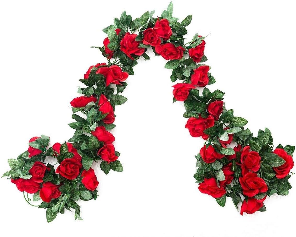 Artificial red rose vine garland with green leaves, displayed on a white background.