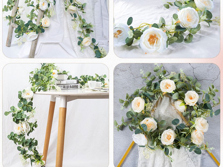 Artificial white rose and eucalyptus flower garland draped over a ladder and on a table with books and teacups.