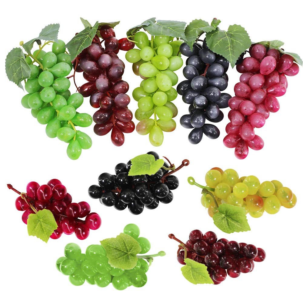Assorted frosted artificial grape clusters in five colors on a white background