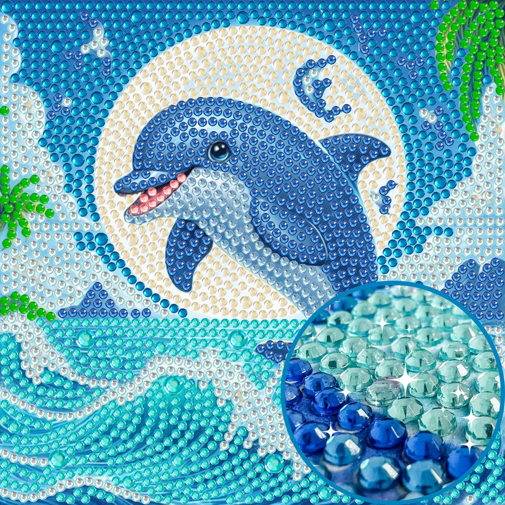 Diamond art painting of a dolphin jumping through a full moon over ocean waves, with a close-up inset of blue and green crystals.