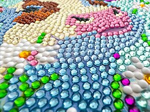 Close-up of a diamond art painting of an axolotl, showing colorful crystal diamonds adhered to a canvas.
