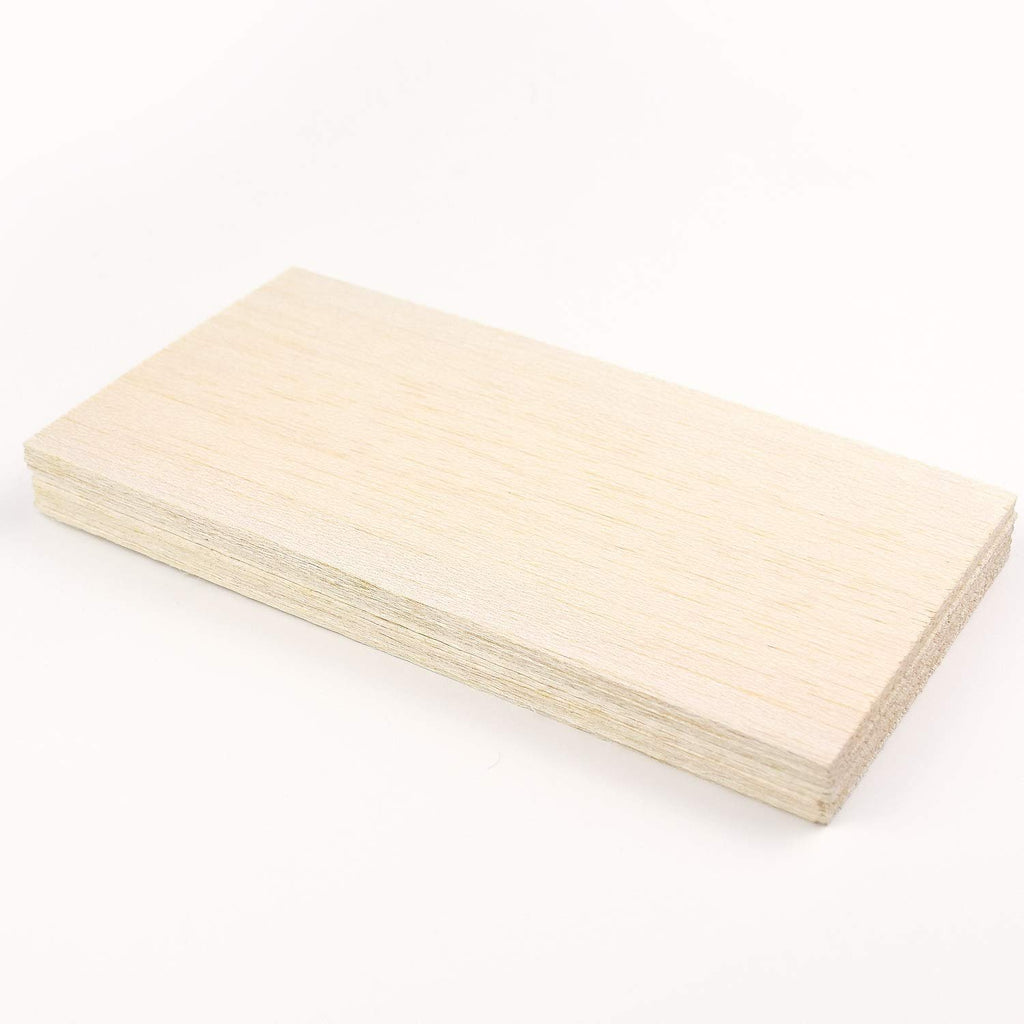 Stack of unfinished balsa wood sheets on a white background, viewed from a slight angle.