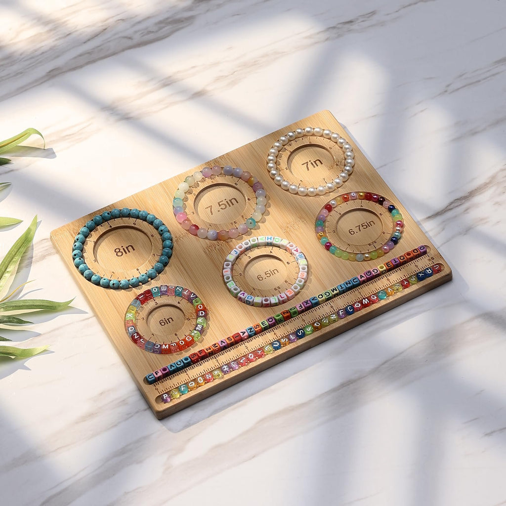 Bamboo jewelry making board with bracelets and beads laid out, showing size guides.