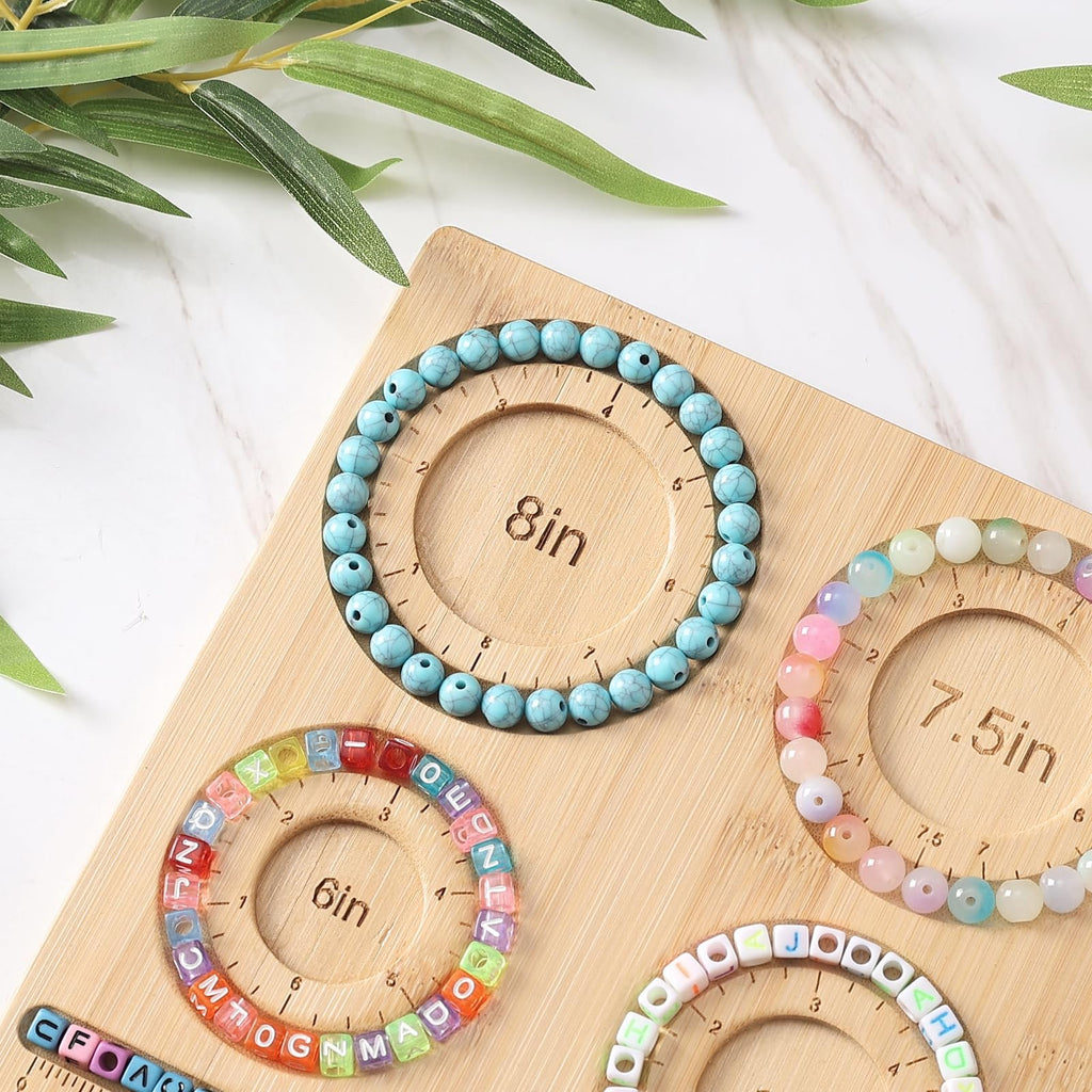 Bamboo bead board with bracelets made of turquoise, colorful, and letter beads, showing size markings for jewelry making.