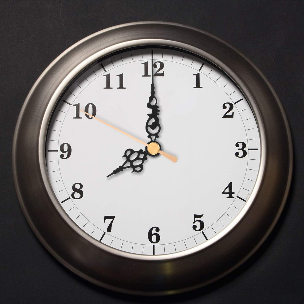 Close-up of a round analog clock face with black numbers and hands against a dark background.