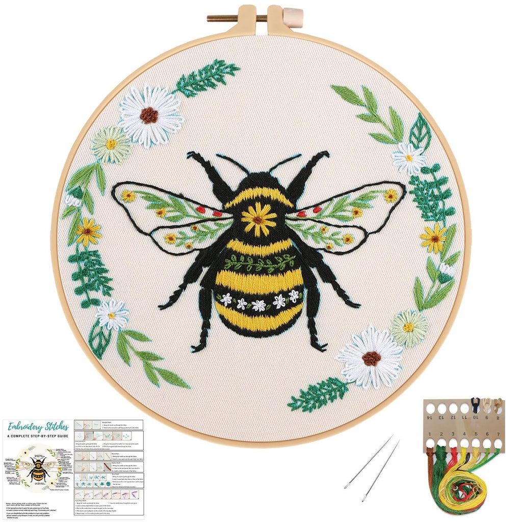 Embroidery hoop with a bee and floral design, includes instruction sheet and thread kit.