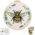 Embroidery hoop with a bee and floral design, includes instruction sheet and thread kit.