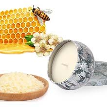 Beeswax candle making kit components including honeycomb with bee, wax flakes in a bowl, and a finished candle in a decorative tin.