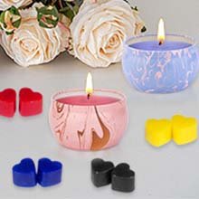 Beeswax candle making kit with two lit candles in decorative tins and heart-shaped wax melts.