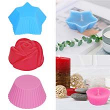 Candle making molds in star, rose, and cupcake shapes, with finished candles in star and cupcake shapes.