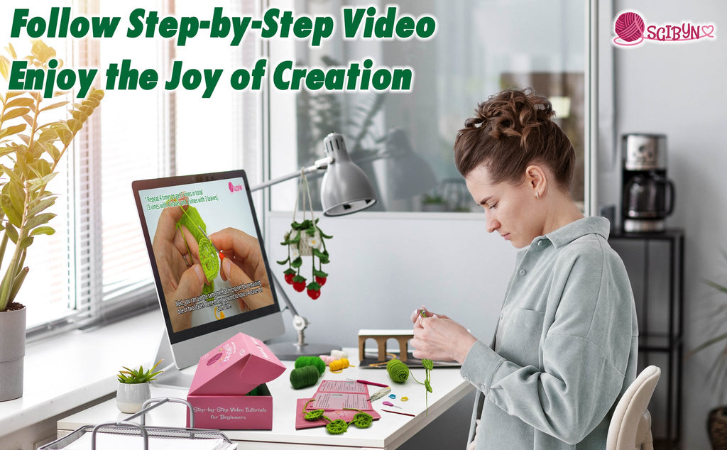 Woman crocheting at a desk with a computer displaying a tutorial for a hanging succulent plant kit.