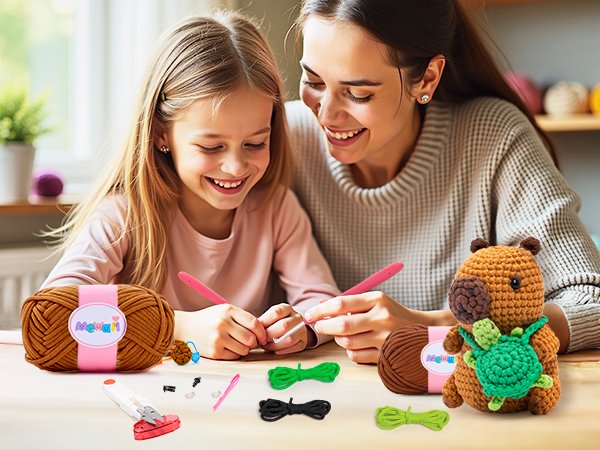 Mother and daughter happily crocheting a capybara toy with yarn and tools on a table