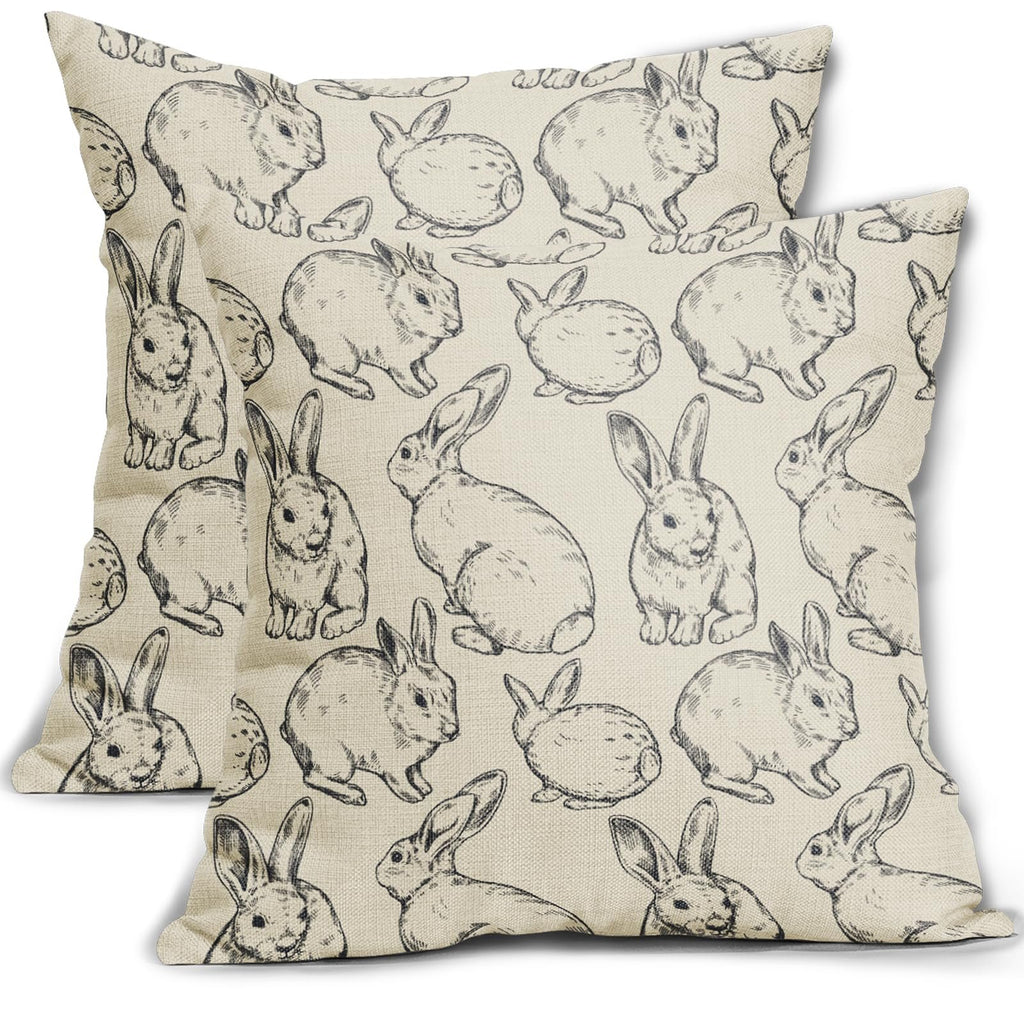 Two linen pillow covers with a black sketch pattern of various Easter bunnies on a white background.