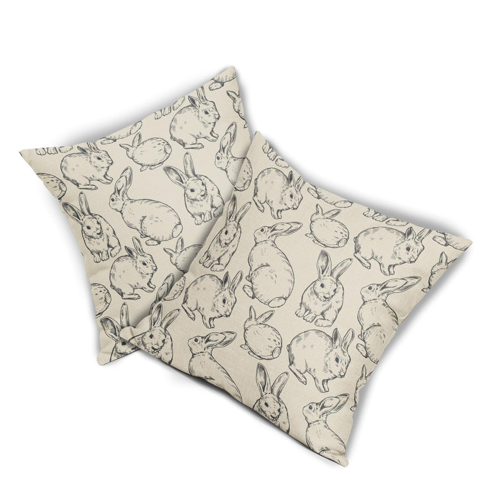 Two linen pillow covers with a black Easter bunny sketch pattern, shown at an angle on a white background.