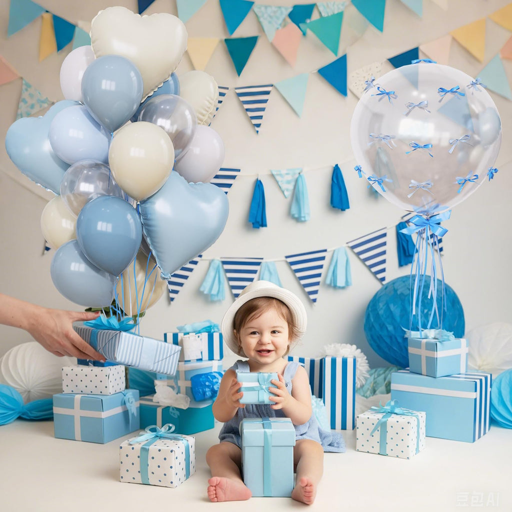 Baby sitting among blue and white gifts with a bouquet of balloons, wearing a white hat.