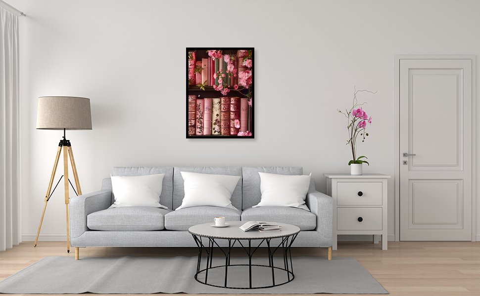 Framed paint by numbers artwork of pink books and flowers on a shelf, displayed in a living room setting.