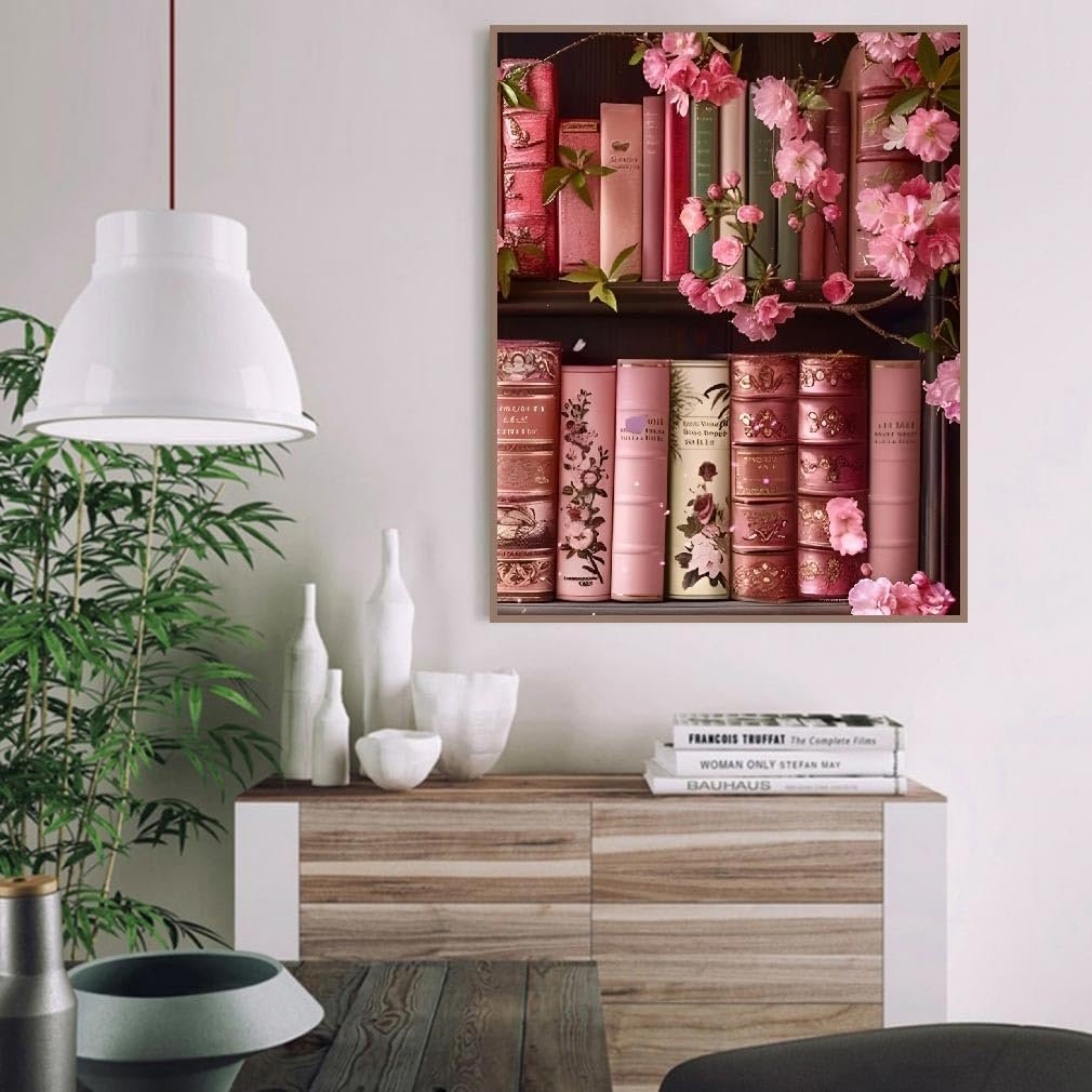 A framed painting of vintage books on shelves adorned with pink cherry blossoms.