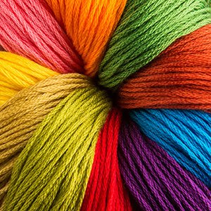 Colorful embroidery threads arranged in a circular pattern, showcasing a variety of vibrant colors.