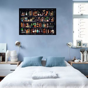 Stamped cross stitch kit depicting a bookshelf with potions, books, and skulls, hanging on a blue wall above a bed.