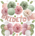 Bridal shower decoration kit with rose gold foil balloons spelling 'BRIDE TO BE', paper lanterns, tissue paper pom poms, and latex balloons in sage green, rose pink, and white.