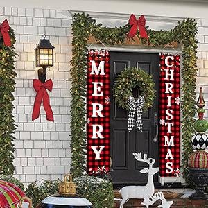 Buffalo plaid Merry Christmas porch banner set hanging on a decorated front door with a wreath and garland.