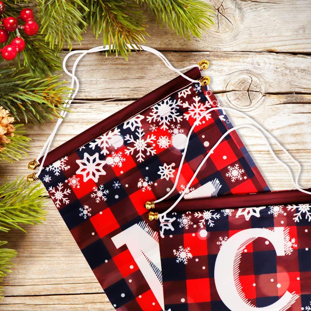 Two buffalo plaid Christmas banners with snowflakes and white letters 'M' and 'C' on a wooden background with pine branches.