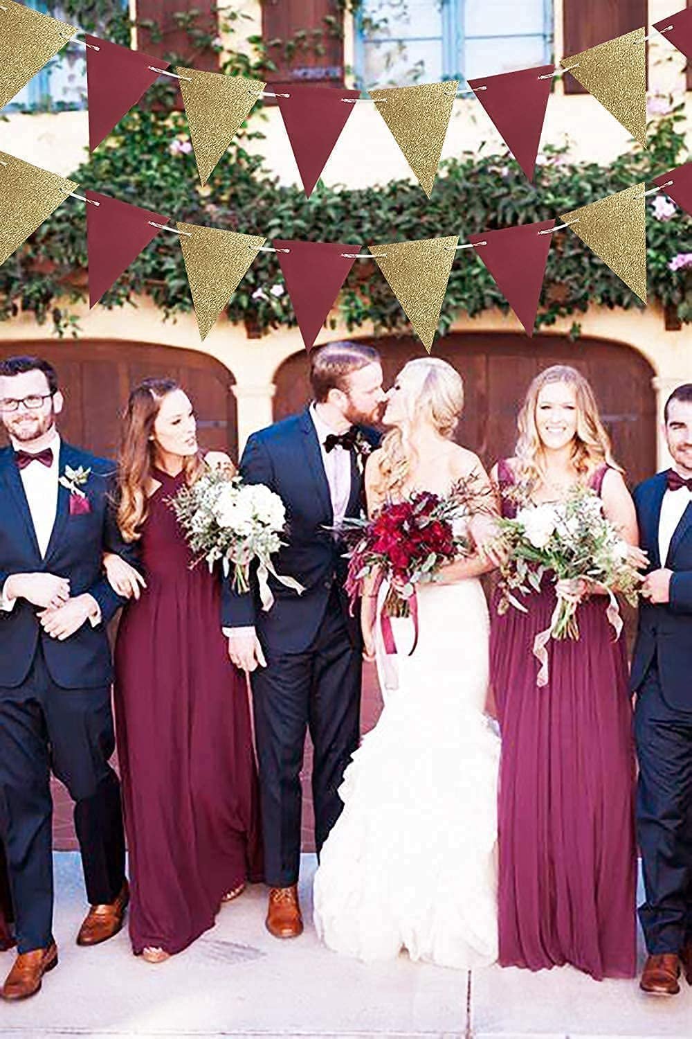 Burgundy and gold glitter triangle bunting garland draped above a wedding party