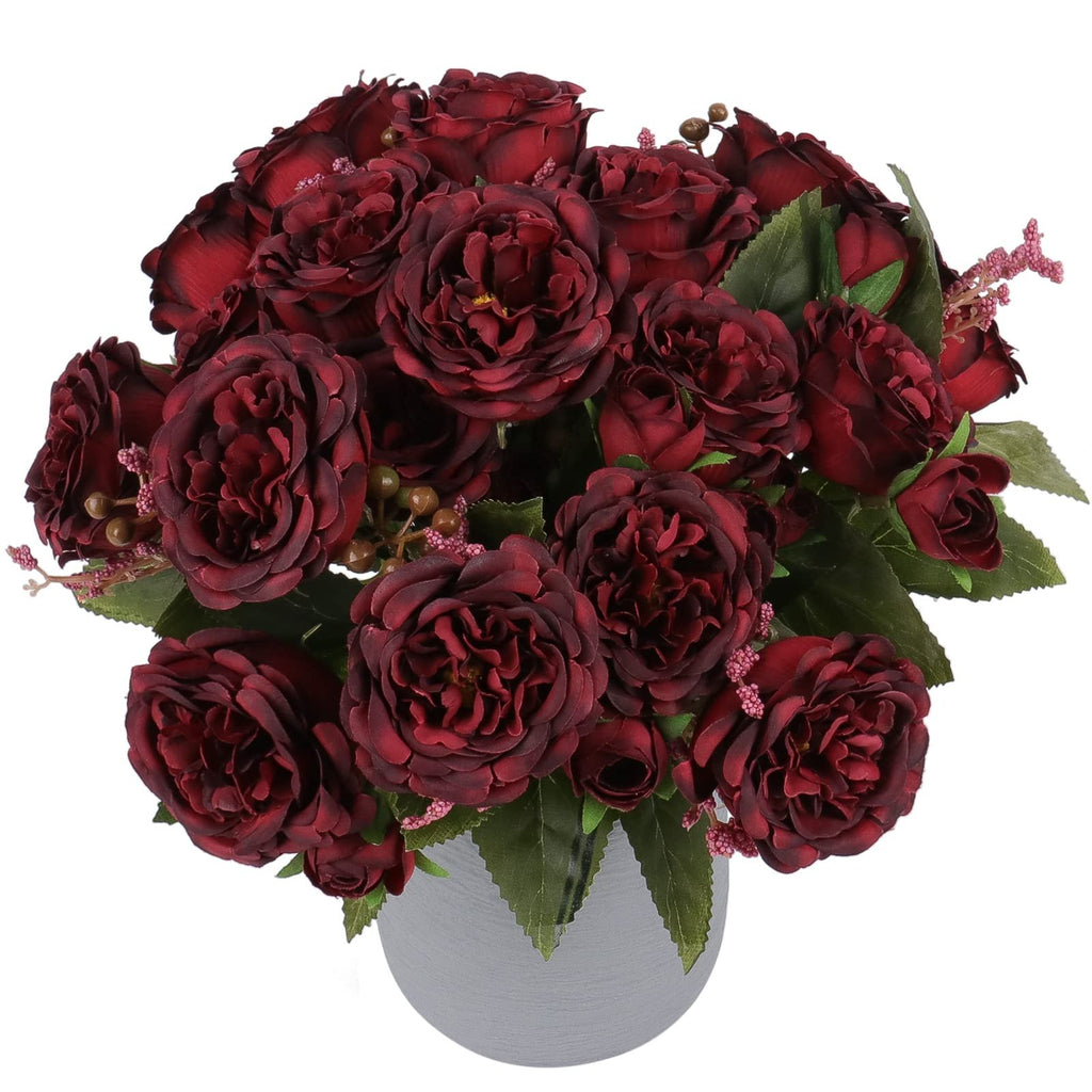 Burgundy artificial peonies in a gray vase, front view. The bouquet features multiple flower heads and green leaves.